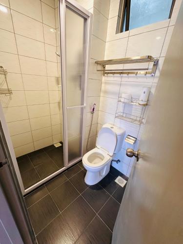 a bathroom with a toilet and a shower at Sungai palas Horizon in Cameron Highlands