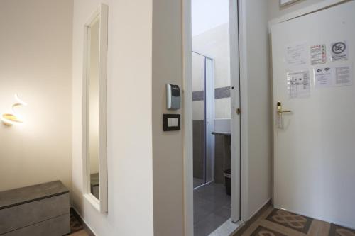 a hallway with a door leading to a bathroom at Rosa Italia Hotel Roma in Rome