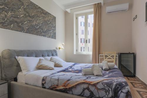 a bedroom with a large bed with pillows on it at Rosa Italia Hotel Roma in Rome