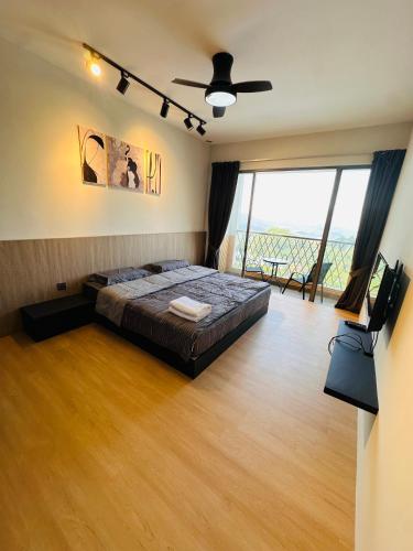 a bedroom with a bed and a large window at Sungai palas Horizon in Cameron Highlands