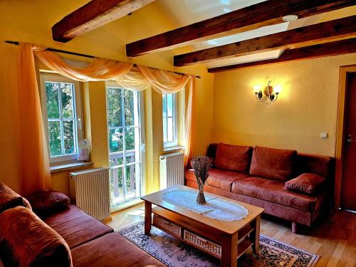 a living room with a couch and a table at Ferienhäuser Harmonie I & II in Burg Kauper