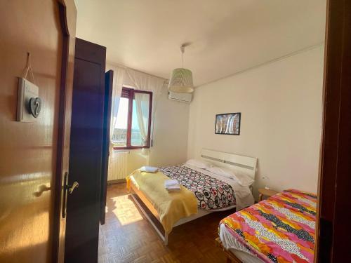 a small bedroom with a bed and a window at B&B Colombo in Pisa