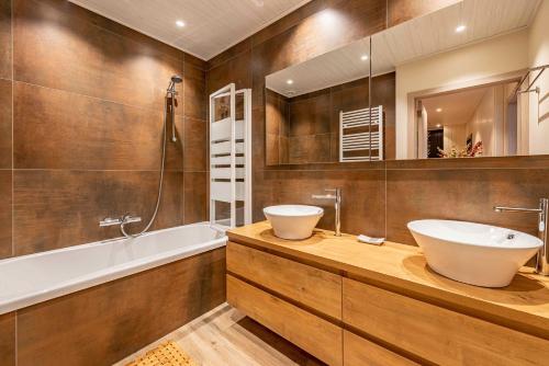 a bathroom with a sink and a bath tub and a sink at Le charron in Bièvre
