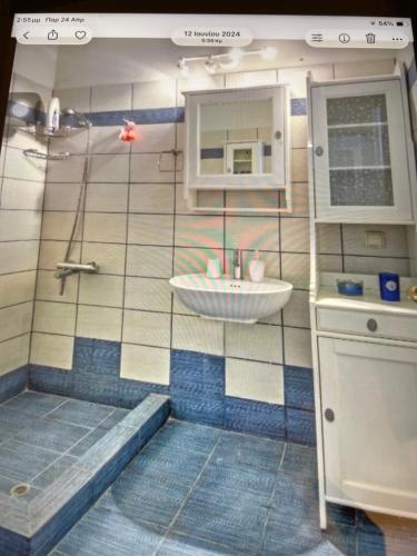 a small bathroom with a sink and a shower at Villa Vassia in Koundouros