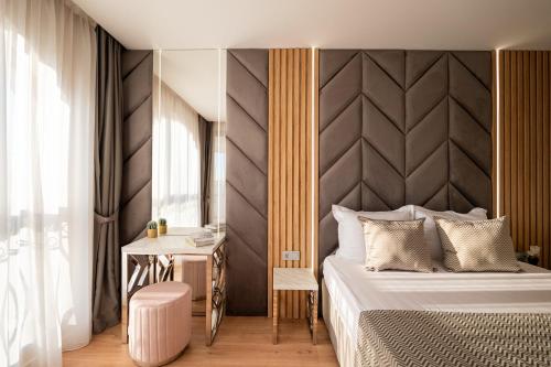 a bedroom with a large bed and a table at Harmony Suites - Dream Island in Sunny Beach