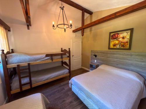 a bedroom with two bunk beds and a chandelier at Hueso cue 105 in Paso de la Patria