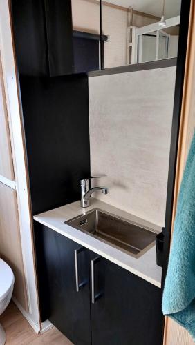 a kitchen with a sink in a small room at Beach Resort Kamperland - 765 in Kamperland