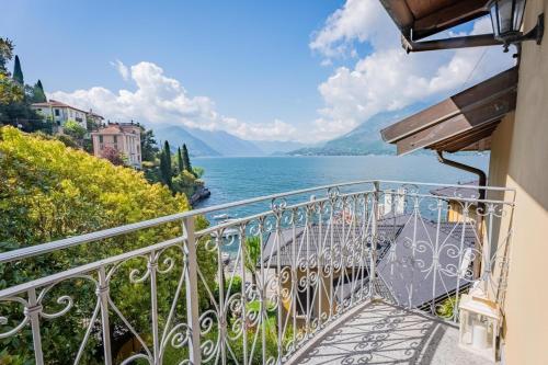 a balcony with a view of the water at Marble House Varenna Lake Como in Varenna