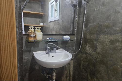 a bathroom with a sink and a mirror at Guma Modern HanokStay in Daegu