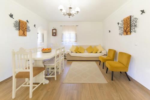 a kitchen and living room with a table and chairs at Celestial Melides Country House in Melides