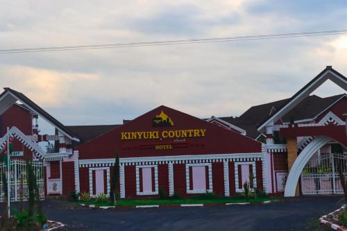 a red and white building with a sign on it at Kinyuki Country Hotel in Nanyuki