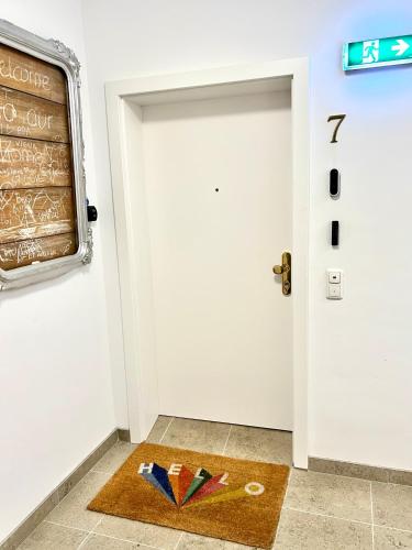 a door mat with books on the floor next to a door at Gmunden Skyline in Gmunden