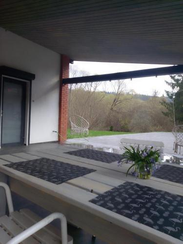 a patio with a table and chairs and a window at Riverside in Slavske
