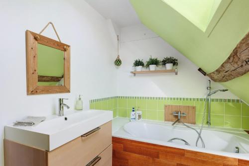 a bathroom with a sink and a bath tub at Longère Pierre De Ronsard piscine in Rilly-sur-Loire