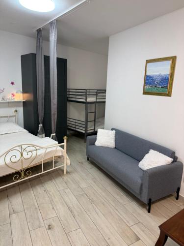 a bedroom with a couch and a bed and bunk beds at San Nicolò in Umag