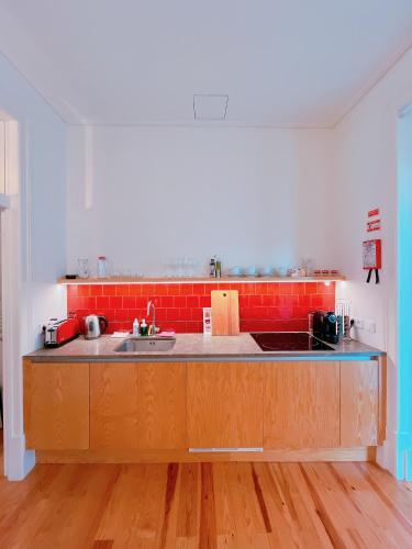 a kitchen with a sink and a counter top at Casa René - Charming apartments in Almada