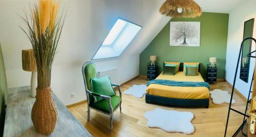a bedroom with a bed and a chair and a window at Résidence Les beaux jours in Neufchâtel-Hardelot