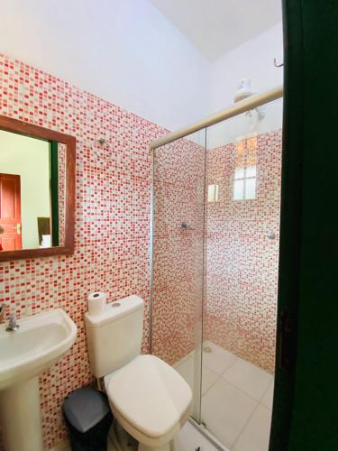 a bathroom with a toilet and a sink and a shower at Hospedaria Estrada Real in Tiradentes