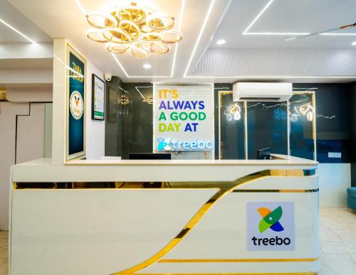 a reception desk in a store with a sign at Treebo Vistara Gold Ujjain Junction in Ujjain