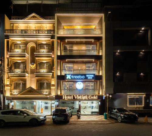 a building with cars parked in front of it at Treebo Vistara Gold Ujjain Junction in Ujjain