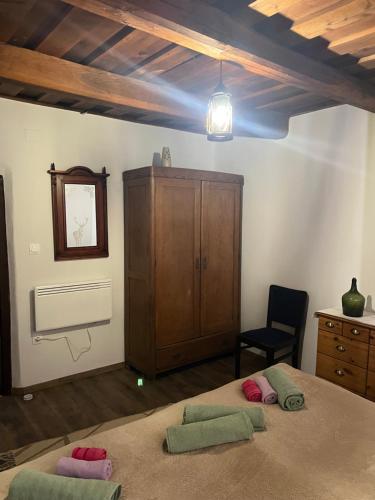 a bedroom with two beds and a wooden cabinet at Bedi Vendégház in Nagybakónak