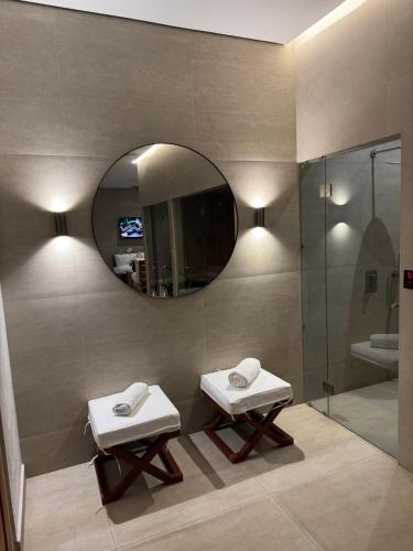 a bathroom with two sinks and a mirror at Tucan Resort & Spa in Paramaribo