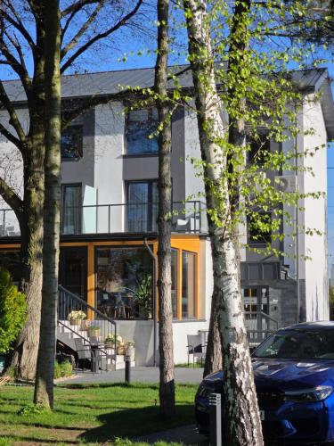 a house with trees in front of it at W64 Apartamenty in Płock