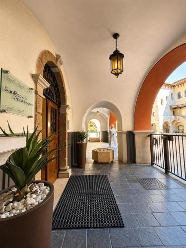a hallway of a building with a potted plant at San Rocco Apartments 2 in Riva del Garda
