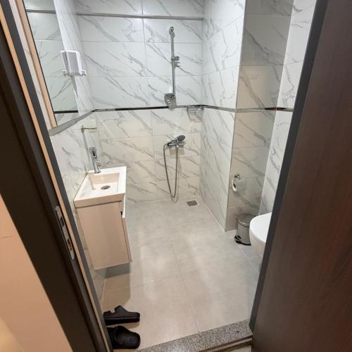 a bathroom with a shower and a sink at İtil Deluxe Eskişehir in Eskisehir