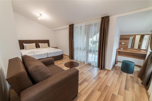 a living room with a bed and a couch at Smokinite Villa 1 - Pool and BBQ near the beach in Varna City