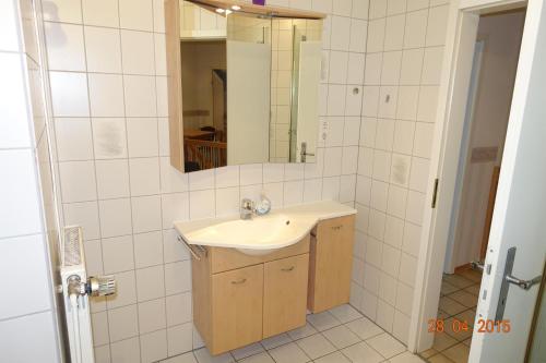 a bathroom with a sink and a mirror at Heidehof Auenland in Wietzendorf