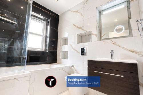 a bathroom with a sink and a mirror at Spacious 4 Bedroom By Tara Stays Short Lets & Serviced Accommodation Aldershot With Free WiFi & Garden in Aldershot