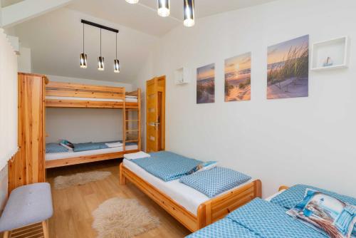 a bedroom with two bunk beds and a desk at Bárka a Tiszához apartman in Tiszaug