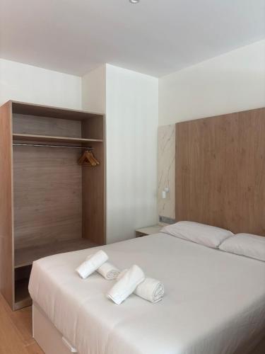 a bedroom with two beds with towels on them at Aravaca Palm in Madrid