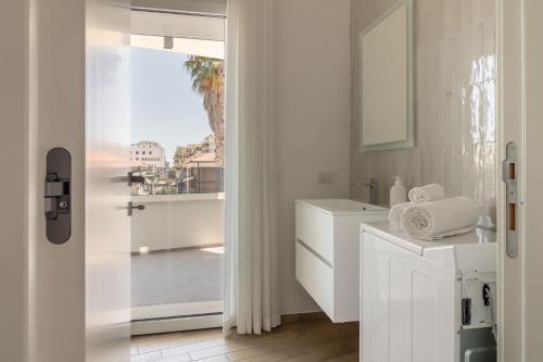a white bathroom with a sink and a window at Palladio13 in San Benedetto del Tronto