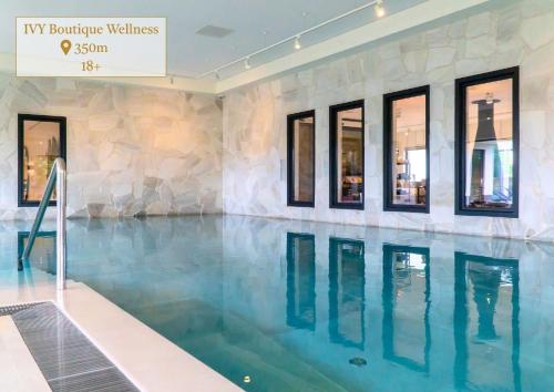 a swimming pool with blue water in a building at Boerderie De Gouden Leeuw in Voorschoten