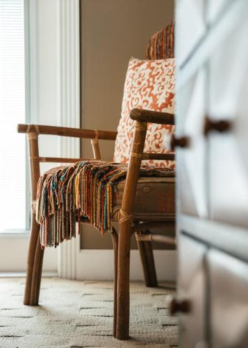 a chair with a blanket sitting in front of a window at At Journey's End in St. Augustine