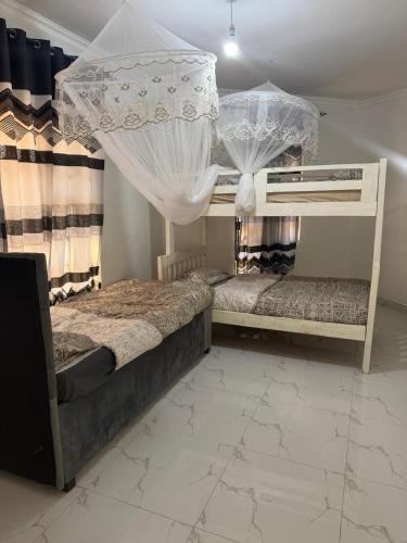 a bedroom with two bunk beds with curtains at Hilltop Villa Sengabay in Salima