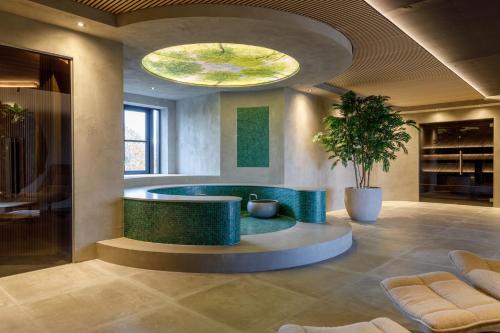 a bathroom with a large tub in the middle of a room at Hotel Asteria in Venray