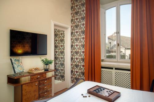 a hotel room with a bed and a window at Hotel Parrasio in Rome