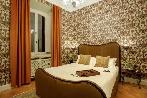 a bedroom with a bed with a box on it at Hotel Parrasio in Rome