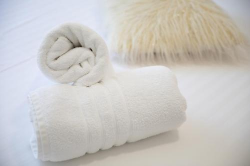 a white towel on top of a white brush at Apartment & Rooms Meri Tučepi in Tučepi