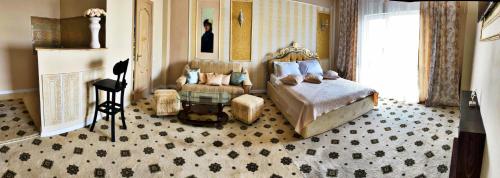 ein Schlafzimmer mit einem Bett, einem Stuhl und einem Tisch in der Unterkunft Diamond Hotel in Chişinău