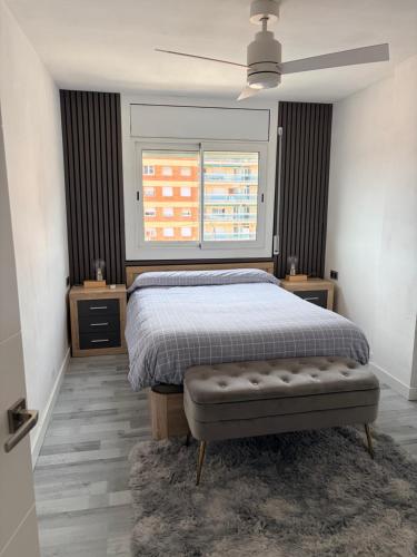 a bedroom with a bed and a large window at Apartamento Malgrat de mar in Malgrat de Mar