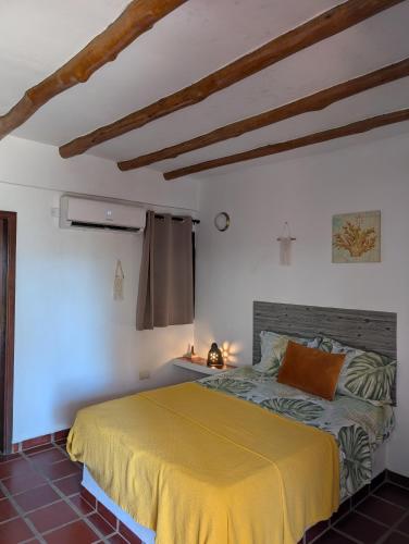 a bedroom with a bed in a white room at Casa Brisa Marina El Yaque in El Yaque