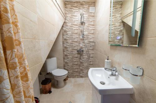 a bathroom with a sink and a toilet and a shower at Smokinite Villa 1 - Pool and BBQ near the beach in Varna City