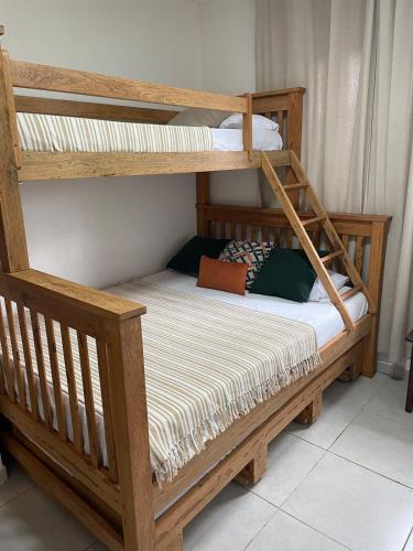 a couple of bunk beds in a room at Chalé Gravatá in Gravatá