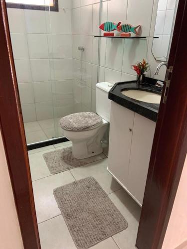 a bathroom with a toilet and a sink and a shower at Chalé Gravatá in Gravatá