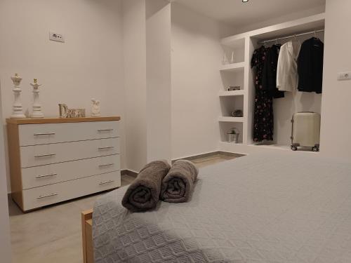 a bedroom with a bed with towels on it at Sunrise House in Kefalos