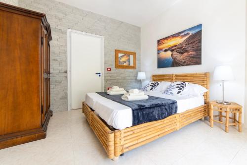 a bedroom with a large bed in a room at Baia Verde - Sea Rooms in Baia Verde